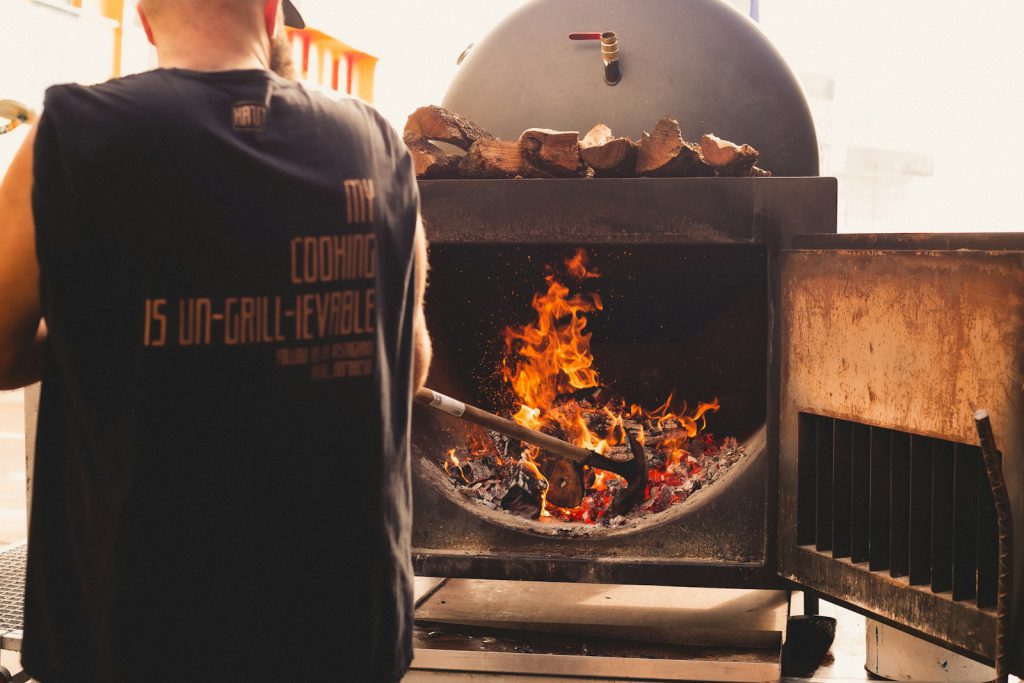 a man standing in front of a smoker