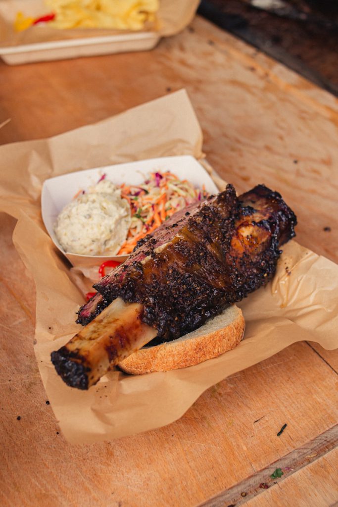 a plate of beef ribs on a wooden table